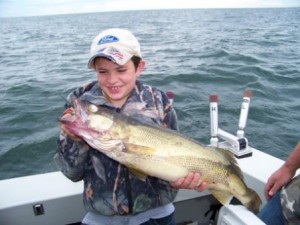 Familys love their fun in the sun vacation allowing opportunities such as this young man catching a true trophy walleye of a lifetime on bring it on walleye charters