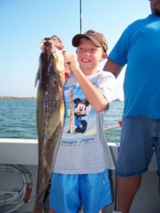 a young man holding a trophy walleye taken on bring it on lake erie charters out of ashtabula ohio lake erie